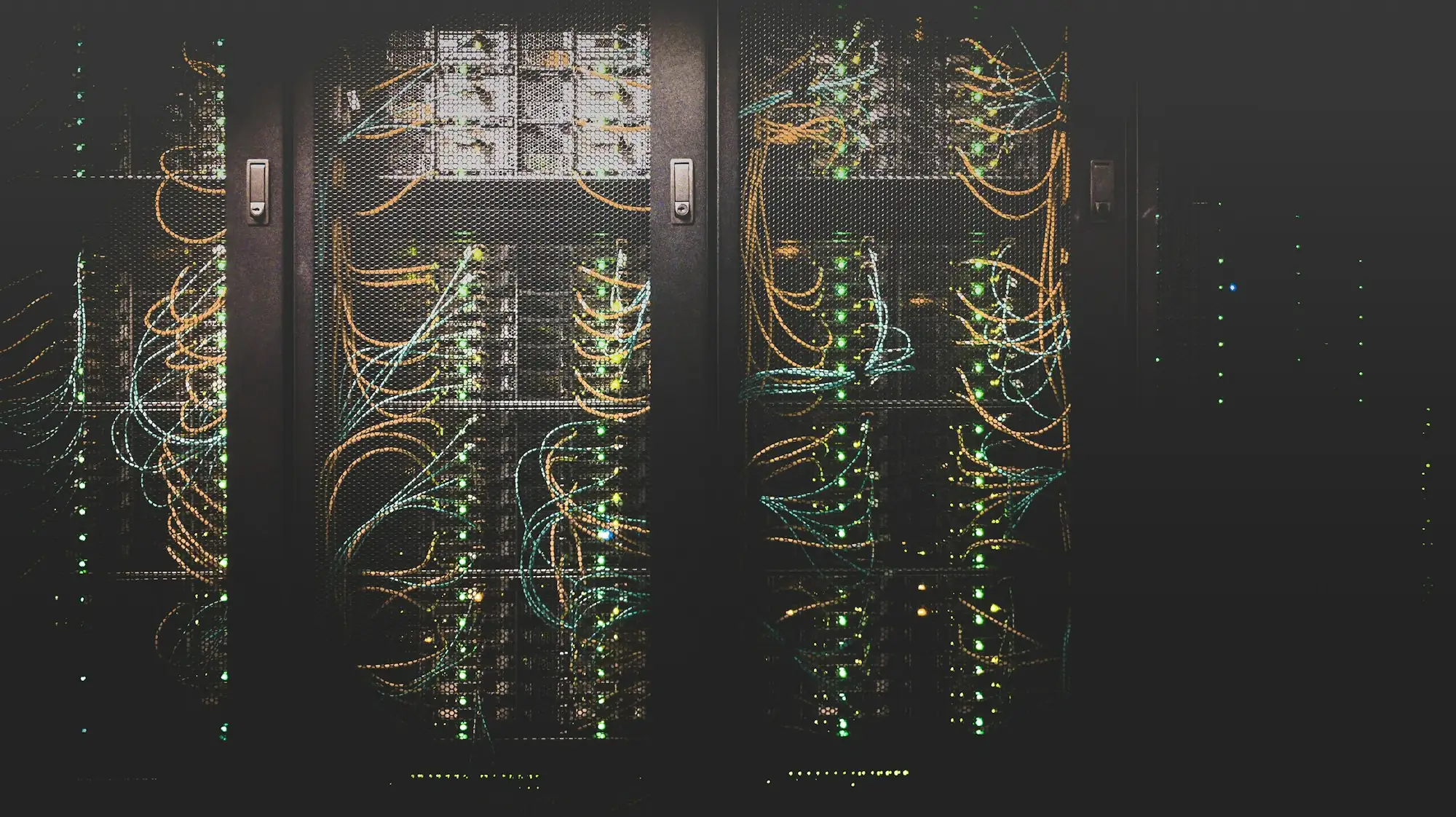 Rows of server racks with network cabling in a data center